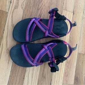 Child Chaco sandals. Purple and pink webbing with purple soles